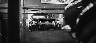Classic car parked inside an auto repair garage